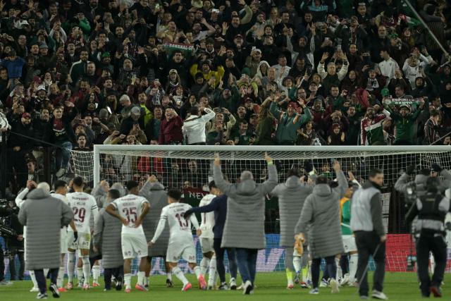 Fluminense players celebrate with fans after advancing to the semifinals at the end of the Copa Libertadores quarter-final second leg football match between Argentina's Platense and Brazil's Fluminense at the Ciudad de Vicente Lopez stadium in Vicente Lopez, Buenos Aires province, Argentina on September 15, 2026. (Photo by JUAN MABROMATA / AFP)