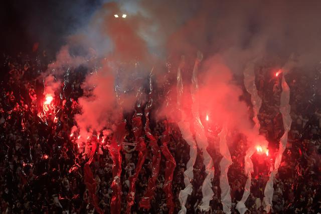Sao Paulo fans light red flares ahead of the Copa Sudamericana quarter-final second leg football match between Brazil's Sao Paulo and Argentina's Boca Juniors at the Morumbi stadium in Sao Paulo, Brazil on September 15, 2026. (Photo by Miguel SCHINCARIOL / AFP)