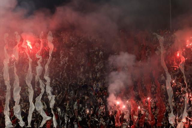 Sao Paulo fans light red flares ahead of the Copa Sudamericana quarter-final second leg football match between Brazil's Sao Paulo and Argentina's Boca Juniors at the Morumbi stadium in Sao Paulo, Brazil on September 15, 2026. (Photo by Miguel SCHINCARIOL / AFP)