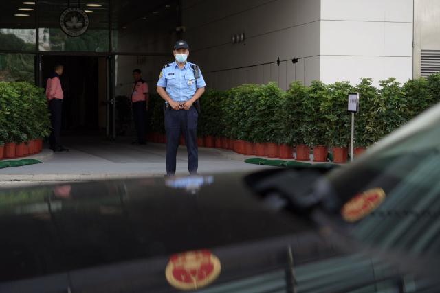 Police keep watch outside the Court of First Instance in Macau on September 16, 2026. Macau is holding its first national security trial behind closed doors on September 16, in a case against a former pro-democracy lawmaker charged with "subversion". (Photo by Catherine LAI / AFP)