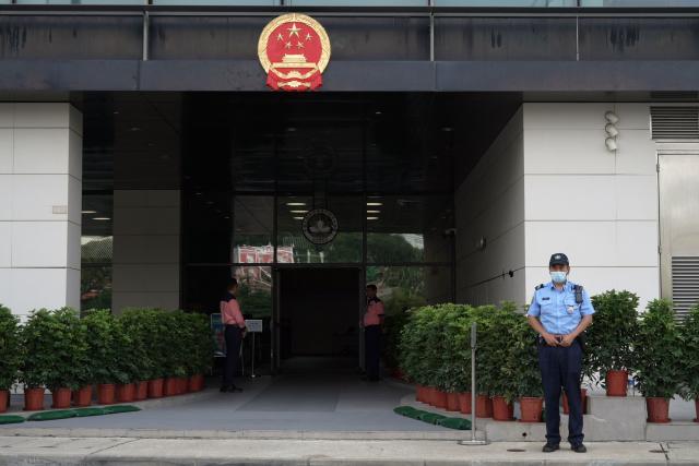 Police keep watch outside the Court of First Instance in Macau on September 16, 2026. Macau is holding its first national security trial behind closed doors on September 16, in a case against a former pro-democracy lawmaker charged with "subversion". (Photo by Catherine LAI / AFP)