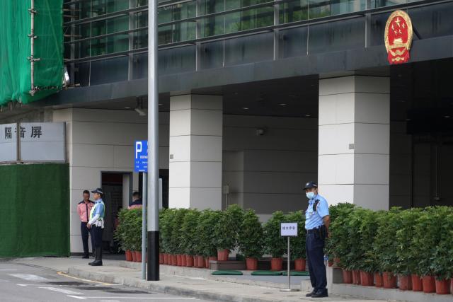Police keep watch outside the Court of First Instance in Macau on September 16, 2026. Macau is holding its first national security trial behind closed doors on September 16, in a case against a former pro-democracy lawmaker charged with "subversion". (Photo by Catherine LAI / AFP)