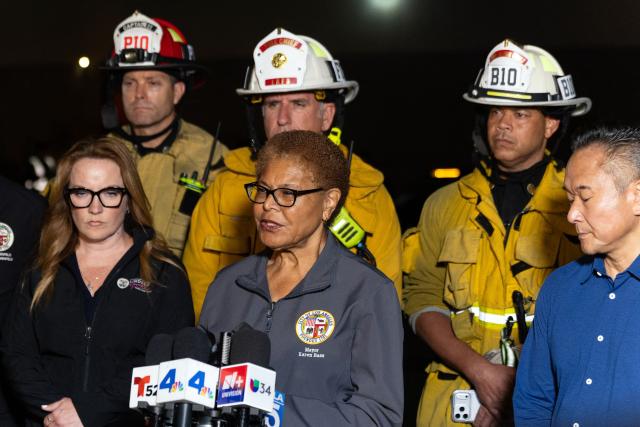 Los Angeles Mayor Karen Bass (C) briefs reporters after a US news media helicopter covering a deadly bus crash, came down in Chatsworth, a neighborhood of Los Angeles, California on September 15, 2026. Three people were killed and one person was hospitalized after the helicopter crashed between two commercial buildings,  igniting on fire instantly, according to the Los Angeles Fire Department. (Photo by Blake Fagan / AFP)