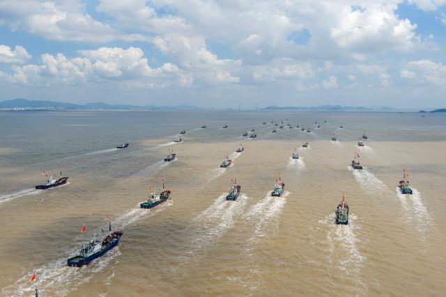 Fishing boats sail out of Ningbo, in eastern China's Zhejiang Province on September 16, 2026. (Photo by CN-STR / AFP) / China OUT