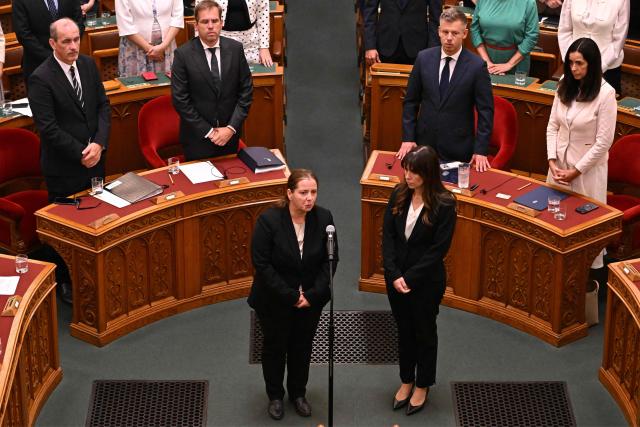(FILES) Hungarian political scientist Anna Unger (L) takes her oath with her deputy  Katalin Tasnadi (R) after they were elected by the National Assembly in a secret ballot on August 28, 2026, for the head and deputy chief of the National Asset Recovery and Asset Protection Office (NVVH). From overpriced toy motorcycles to a controversial train deal with Egypt, Hungary's new government is seeking to review alleged corruption under ex-premier Viktor Orban.But even the country's new top anti-graft official warns that getting convictions will take many years after pro-EU conservative Peter Magyar's April win. (Photo by Attila KISBENEDEK / AFP)