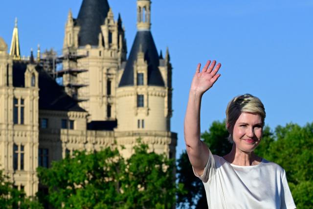 (FILES) Manuela Schwesig, Mecklenburg-Western Pomerania's State Premier and the Social Democratic Party's (SPD) top candidate for the upcoming regional elections in the northern German state of Mecklenburg-Western Pomerania, waves at the end of her speech at an election campaign rally on August 14, 2026 with Schwerin Castle in the background in Schwerin, northern Germany. Germany's anti-immigration AfD is eyeing another election triumph on September 20, 2026 in the northeastern coastal state of Mecklenburg-Western Pomerania, where the popular premier Manuela Schwesig is campaigning on the promise she can hold back a rising far-right tide. Schwesig of the centre-left SPD -- a cancer survivor with high personal approval ratings and a large social media following -- is fighting a battle watched closely across Germany. The AfD's candidate for State Premier Leif-Erik Holm, 56, is not known for the radical edge or charisma of some other AfD figures but has every chance of cruising to victory on the party's current momentum. (Photo by John MACDOUGALL / AFP)
