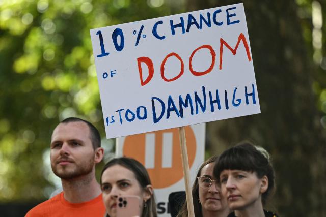 People hold placards during a "emergency protest" by civic action group PauseAI UK outside Downing Street in central London on September 16, 2026, after news that AI researcher Jacob Coxon has decided to leave the industry. The world's biggest AI companies are working on creating a standards body, ChatGPT-maker OpenAI said on September 15, as fears rise about the dangers of AI and pressure is on to create a safer version of the technology. Earlier this month researcher Coxon, who had previously worked at OpenAI, left Anthropic and warned that AI labs were "gambling with our lives." (Photo by JUSTIN TALLIS / AFP)