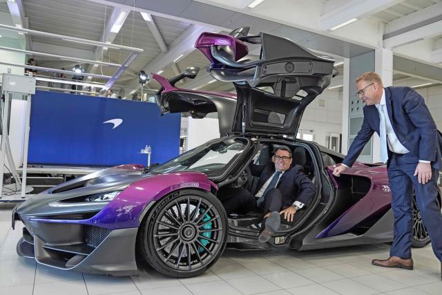 Nick Collins (R), chief executive officer of McLaren Group, looks on as Britain's Prime Minister Andy Burnham (L) sits inside a McLaren W1 during a visit to meet apprentices and workers on the production lines at the McLaren Technology Centre in Woking, Surrey, south-west of London on September 16, 2026. (Photo by Stefan Rousseau / POOL / AFP)