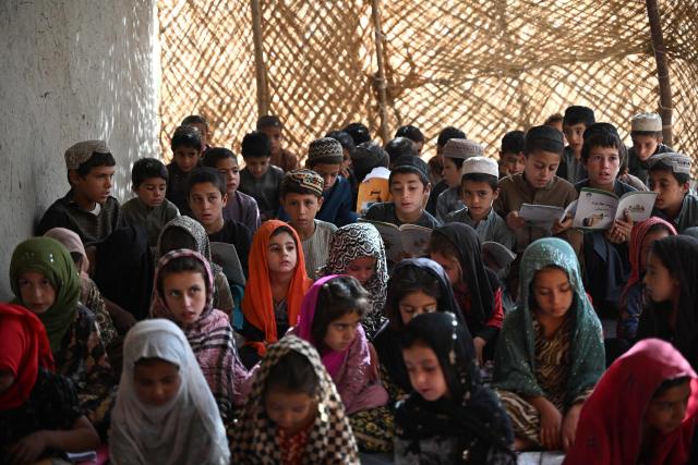 Afghan children attend a class at a school in Zhari district of Afghanistan's Kandahar province on September 16, 2026. (Photo by Sanaullah SEIAM / AFP)