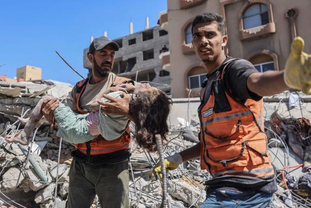 EDITORS NOTE: Graphic content / A rescuer carries the body of a Palestinian girl at the site of a collapsed building in the Tal al-Hawa area of Gaza City on September 16, 2026. Gaza authorities said on September 16 that at least 20 people including five children had died and dozens more were missing after an apartment building collapsed from damage sustained in earlier Israeli strikes. The six-storey building, which had four apartments per floor, crumbled overnight onto nearby homes and tents in the Tal al-Hawa area of Gaza City, according to the civil defence agency, which works as a rescue service under Hamas authority. (Photo by Omar AL-QATTAA / AFP)