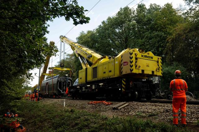 Railway workers oversee the removal operation of a derailled train carriage in Cleon, northwestern France, on September 16, 2026. France's interior minister on September 13 urged caution as authorities investigated the derailment of a train that injured 44 people, amid questions over whether the incident could have been an act of sabotage. The train, carrying 186 passengers, derailed on September 11 between the Normandy cities of Rouen and Caen in northwestern France, leaving many badly shaken, officials said. (Photo by Guillaume SALIGOT / AFP)
