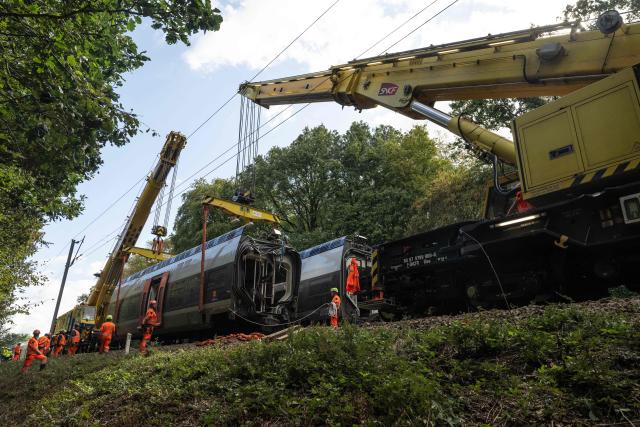 Railway workers work on the removal of a derailed train carriage in Cleon, northwestern France, on September 16, 2026. France's interior minister on September 13 urged caution as authorities investigated the derailment of a train that injured 44 people, amid questions over whether the incident could have been an act of sabotage. The train, carrying 186 passengers, derailed on September 11 between the Normandy cities of Rouen and Caen in northwestern France, leaving many badly shaken, officials said. (Photo by Guillaume SALIGOT / AFP)