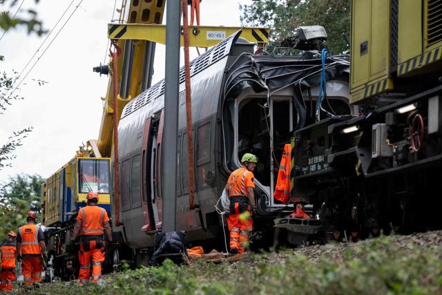 Railway workers work on the removal of a derailed train carriage in Cleon, northwestern France, on September 16, 2026. France's interior minister on September 13 urged caution as authorities investigated the derailment of a train that injured 44 people, amid questions over whether the incident could have been an act of sabotage. The train, carrying 186 passengers, derailed on September 11 between the Normandy cities of Rouen and Caen in northwestern France, leaving many badly shaken, officials said. (Photo by Guillaume SALIGOT / AFP)