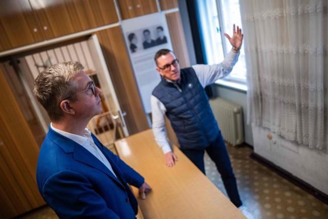 Berlin's senator for culture Stefan Evers (L) listens to former inmate Mario Roellig (R) as he visits the former prison of the East German communist-era secret police, known as the Stasi, at Hohenschoenhausen in Berlin on September 16, 2026. The complex, now a museum and memorial, included interrogation and detention facilities as well as underground cells where the regime's critics underwent relentless psychological torture. Evers is the Christian Democratic Union's (CDU) main candidate in upcoming regional elections in Berlin. (Photo by John MACDOUGALL / AFP)