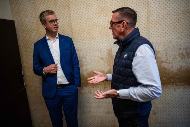 Berlin's senator for culture Stefan Evers (L) listens to former inmate Mario Roellig (R) as he visits the former prison of the East German communist-era secret police, known as the Stasi, at Hohenschoenhausen in Berlin on September 16, 2026. The complex, now a museum and memorial, included interrogation and detention facilities as well as underground cells where the regime's critics underwent relentless psychological torture. Evers is the Christian Democratic Union's (CDU) main candidate in upcoming regional elections in Berlin. (Photo by John MACDOUGALL / AFP)