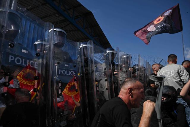 Riot police officers stand guard  as people protest in front of the EULEX headquarters in Pristina on September 16, 2026, after the Kosovo Specialist Chambers in The Hague convicted former Kosovo president Hashim Thaci and three former guerrilla commanders of war crimes. Kosovo's former president Hashim Thaci was sentenced to 25 years by a tribunal in The Hague on September 16, 2026 for war crimes, the court said in a long-awaited verdict likely to spark outrage in the Balkan country. (Photo by Armend NIMANI / AFP)