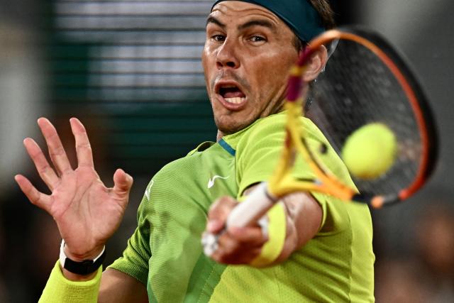 (FILES) Spain's Rafael Nadal returns the ball to Serbia's Novak Djokovic during their men's singles match on day ten of the Roland-Garros Open tennis tournament at the Court Philippe-Chatrier in Paris on May 31, 2022. Retired Spanish tennis player Rafael Nadal will return to the court in front of a crowd for the first time since retirement in October to celebrate his academy's 10th anniversary, AFP reports on September 16, 2026. (Photo by Anne-Christine POUJOULAT / AFP)