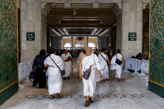 People and pilgrims walk at the Grand Mosque Complex in Saudi Arabia's holy city of Mecca on September 16, 2026. (Photo by AFP)