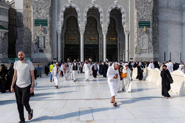 People and pilgrims walk at the Grand Mosque Complex in Saudi Arabia's holy city of Mecca on September 16, 2026. (Photo by AFP)