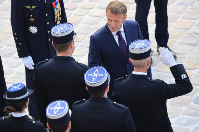 France's President Emmanuel Macron (top c) meets with members of the armed forces during an armed forces decoration ceremony at the Hôtel National des Invalides in Paris on September 16, 2026. (Photo by Ludovic MARIN / AFP)
