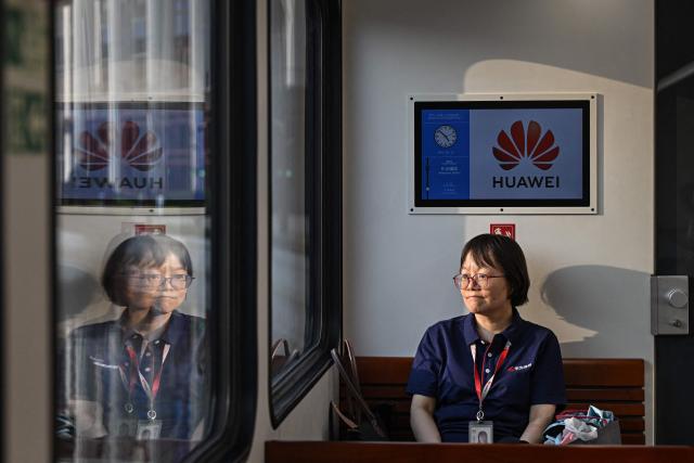 A Huawei employee travels on a shuttle train at Huawei Lianqiu Lake research campus during a media tour in Shanghai on September 16, 2026. (Photo by Jade GAO / AFP)