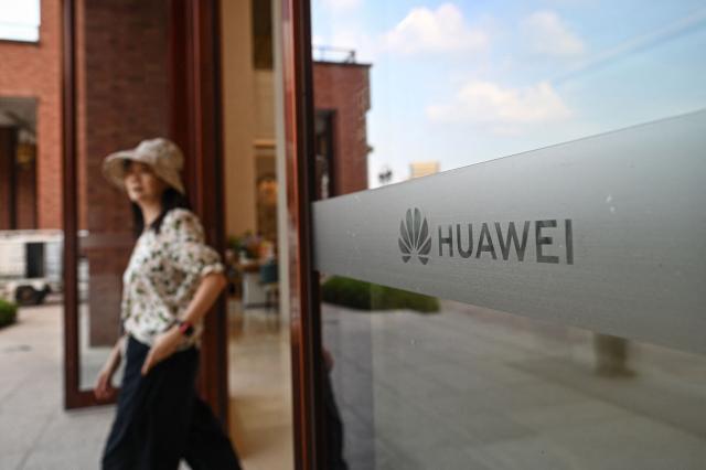 The Huawei logo is seen on a glass at the Huawei Lianqiu Lake research campus during a media tour in Shanghai on September 16, 2026. (Photo by Jade GAO / AFP)