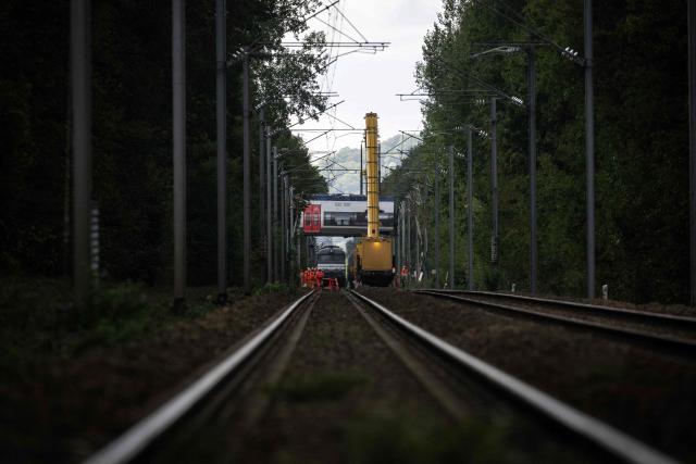 Railway cranes lift a train carriage during the removal operation of a derailed train in Cleon, northwestern France, on September 16, 2026. France's interior minister on September 13 urged caution as authorities investigated the derailment of a train that injured 44 people, amid questions over whether the incident could have been an act of sabotage. The train, carrying 186 passengers, derailed on September 11 between the Normandy cities of Rouen and Caen in northwestern France, leaving many badly shaken, officials said. (Photo by GUILLAUME SALIGOT / AFP)