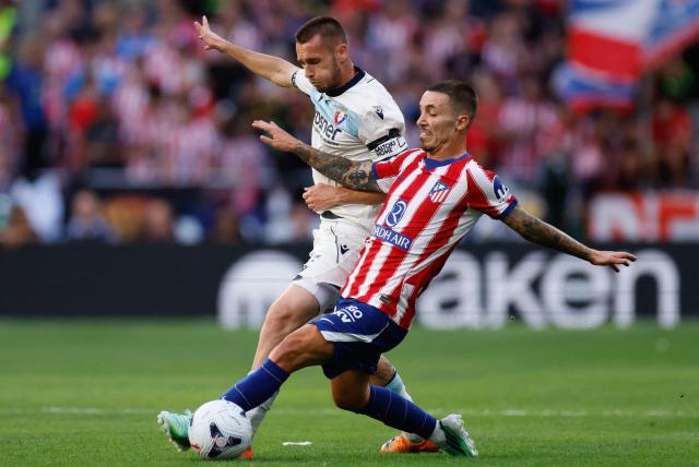 Osasuna's Spanish forward #21 Jonathan Dubasin (L) vies for the ball with Atletico Madrid's Spanish defender #22 Alex Grimaldo during the Spanish league football match between Club Atletico de Madrid and CA Osasuna at the Metropolitano stadium in Madrid on September 16, 2026. (Photo by Oscar DEL POZO / AFP)