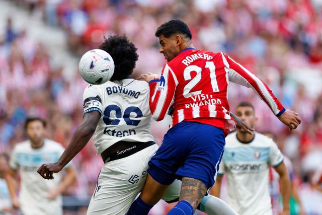 Atletico Madrid's Argentine defender #21 Cristian Romero (R) vies for a header with Osasuna's Cameroonian defender #22 Flavien Boyomo during the Spanish league football match between Club Atletico de Madrid and CA Osasuna at the Metropolitano stadium in Madrid on September 16, 2026. (Photo by Oscar DEL POZO / AFP)
