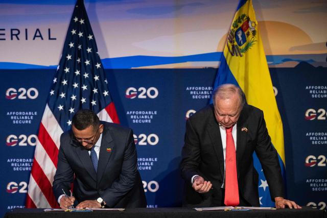 (L/R) Jovanny Martinez, Executive Vice President of the state-owned oil and gas company of Venezuela (PDVSA), and Harold Hamm, chairman of Continental Resources, signs an agreement during the third day of the G20 Ministerial Meeting on Energy Abundance in Houston, Texas on September 16, 2026. The discussions are slated to run through September 16 in Houston, in the oil-rich US state of Texas. The meetings gather delegations from the world's largest economies -- including China, India, Japan and Germany -- with major oil producers set to attend, such as Canada and Saudi Arabia. (Photo by RONALDO SCHEMIDT / AFP)