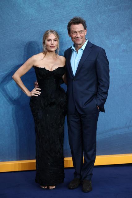 English actor Sienna Miller and English actor Dominic West pose upon arrival on the red carpet for the world premiere of the eight-part television series "WAR", in Leicester Square in central London on September 16, 2026. (Photo by Henry NICHOLLS / AFP)