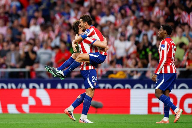 Atletico Madrid's Spanish defender #24 Robin Le Normand (L) celebrates scoring his team's third goal with teammate Atletico Madrid's Spanish midfielder #06 Koke during the Spanish league football match between Club Atletico de Madrid and CA Osasuna at the Metropolitano stadium in Madrid on September 16, 2026. (Photo by Oscar DEL POZO / AFP)