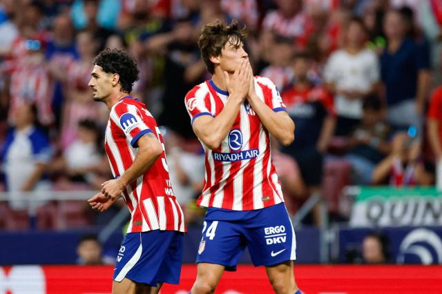 Atletico Madrid's Spanish defender #24 Robin Le Normand (R) celebrates scoring his team's third goal  during the Spanish league football match between Club Atletico de Madrid and CA Osasuna at the Metropolitano stadium in Madrid on September 16, 2026. (Photo by Oscar DEL POZO / AFP)