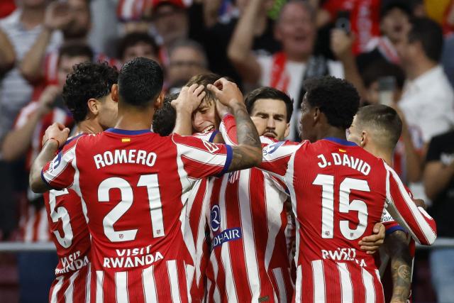 Atletico Madrid's Spanish defender #24 Robin Le Normand (C) celebrates with teammates after scoring his team's third goal  during the Spanish league football match between Club Atletico de Madrid and CA Osasuna at the Metropolitano stadium in Madrid on September 16, 2026. (Photo by Oscar DEL POZO / AFP)