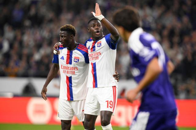 Lyon's Burkinabe defender #76 Mohamed Ouedraogo (L) talks with Lyon's Senegalese defender #19 Moussa Niakhate (C) during the UEFA Europa League, league phase, matchday 1, football match between RSC Anderlecht and Olympique Lyonnais (OL) at Constant Vanden Stock Stadium in Anderlecht, near Brussels on September 16, 2026. (Photo by JOHN THYS / AFP)
