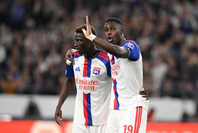 Lyon's Burkinabe defender #76 Mohamed Ouedraogo (L) talks with Lyon's Senegalese defender #19 Moussa Niakhate (C) during the UEFA Europa League, league phase, matchday 1, football match between RSC Anderlecht and Olympique Lyonnais (OL) at Constant Vanden Stock Stadium in Anderlecht, near Brussels on September 16, 2026. (Photo by JOHN THYS / AFP)