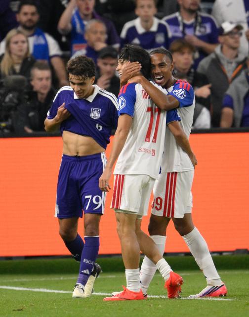 Lyon's Japanese forward #11 Keito Nakamura (C) and Lyon's Danish midfielder #99 Noah Nartey celebrate during the UEFA Europa League, league phase, matchday 1, football match between RSC Anderlecht and Olympique Lyonnais (OL) at Constant Vanden Stock Stadium in Anderlecht, near Brussels on September 16, 2026. (Photo by JOHN THYS / AFP)