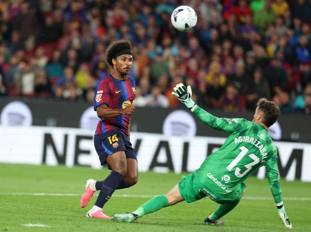 Barcelona's German forward #14 Karim Adeyemi (L) fails to score past Racing Santander's Spanish goalkeeper #13 Julen Agirrezabala during the Spanish league football match between FC Barcelona and Racing Santander at the Camp Nou stadium in Barcelona on September 16, 2026. (Photo by Lluis GENE / AFP)
