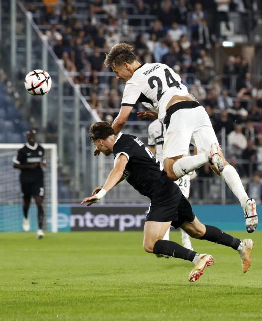 Rennes' French defender #24 Anthony Rouault (top) and Sturm Graz's Austrian forward #26 Belmin Beganovic vie for the ball during the UEFA Europa League between Sturm Graz and Stade Rennais FC in Graz, Austria on September 16, 2026. (Photo by ERWIN SCHERIAU / APA / AFP) / Austria OUT