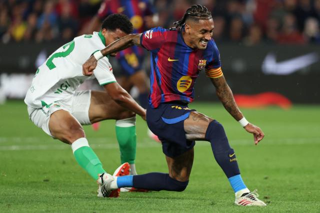 Barcelona's Brazilian forward #11 Raphinha is fouled by Racing Santander's Brazilian defender #22 Pedro Felipe resulting in a penalty during the Spanish league football match between FC Barcelona and Racing Santander at the Camp Nou stadium in Barcelona on September 16, 2026. (Photo by Lluis GENE / AFP)