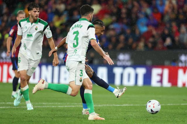 Barcelona's Brazilian forward #11 Raphinha scores his team's fourth goal during the Spanish league football match between FC Barcelona and Racing Santander at the Camp Nou stadium in Barcelona on September 16, 2026. (Photo by Lluis GENE / AFP)