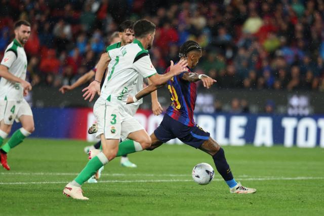 Barcelona's Brazilian forward #11 Raphinha scores his team's fourth goal during the Spanish league football match between FC Barcelona and Racing Santander at the Camp Nou stadium in Barcelona on September 16, 2026. (Photo by Lluis GENE / AFP)