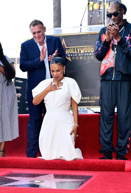 US actress Nia Long reacts to the unveiling of her star at the Hollywood Walk of Fame as US rapper Snoop Dogg (R) and British film producer Graham King (L) applaud during her ceremony in the Hollywood neighborhood of Los Angeles on September 16, 2026. (Photo by Frederic J. BROWN / AFP)