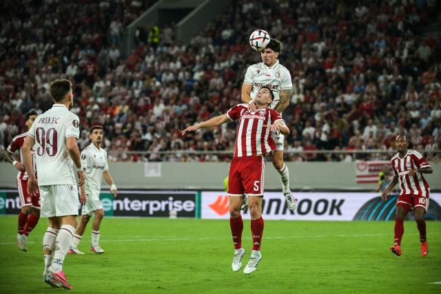 Olympiacos' Italian defender #05 Lorenzo Pirola (DOWN) fights for the ball with Jagiellonia's Portuguese defender #05 Bernardo Vital during the UEFA Europa League first round football match between Olympiacos F.C and Jagiellonia Bialystok at Stadio Georgios Karaiskakis in Athens on September 16, 2026. (Photo by Aris MESSINIS / AFP)