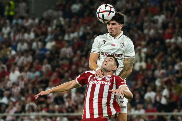 Olympiacos' Italian defender #05 Lorenzo Pirola (DOWN) fights for the ball with Jagiellonia's Portuguese defender #05 Bernardo Vital during the UEFA Europa League first round football match between Olympiacos F.C and Jagiellonia Bialystok at Stadio Georgios Karaiskakis in Athens on September 16, 2026. (Photo by Aris MESSINIS / AFP)