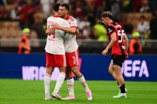 Benfica’s Australian defender #3 Alessandro Circati and Benfica’s Portuguese defender #44 Tomas Araujo celebrate the victory of their team at the end of the UEFA Europa League 1st round day 1 football match between Ac Milan and Benfica at the San Siro Stadium in Milan on September 16, 2026. Benfica won 2-0 over AC Milan. (Photo by Marco Bertorello / AFP)