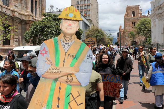 Demonstrators show a cardboard cutout depicting Ecuador's President Daniel Noboa during a march in defense of water resources and against mining projects in Cuenca, Ecuador on September 16, 2026. (Photo by Galo Paguay / AFP)