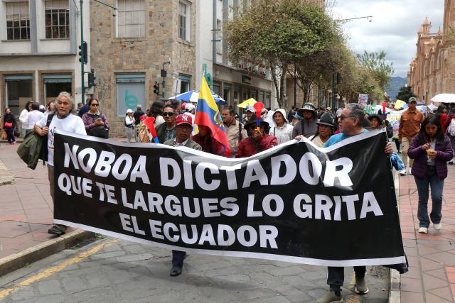 Demonstrators show a banner against Ecuador's President Daniel Noboa during a march in defense of water resources and against mining projects in Cuenca, Ecuador on September 16, 2026. (Photo by Galo Paguay / AFP)