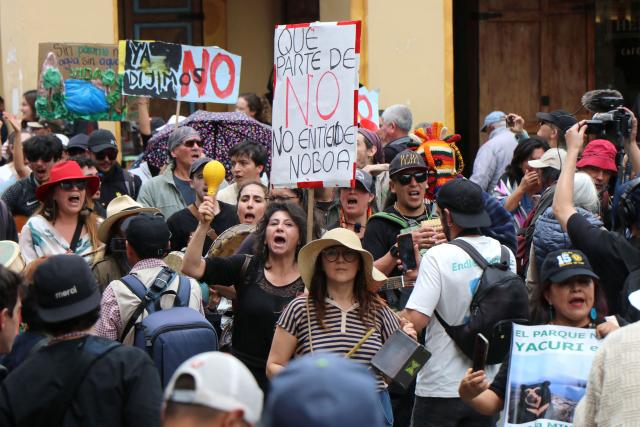 A demonstrator shows a sign against Ecuador's President Daniel Noboa during a march in defense of water resources and against mining projects in Cuenca, Ecuador on September 16, 2026. (Photo by Galo Paguay / AFP)