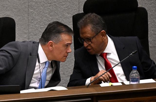 Bolivia's Government Minister Marco Antonio Oviedo (R) and Defense Minister Ernesto Justiniano attend an ordinary session of the Plurinational Legislative Assembly in La Paz on September 16, 2026. The Legislative Assembly session to decide on extending the state of exception measure for another 90 days. (Photo by Aizar RALDES / AFP)